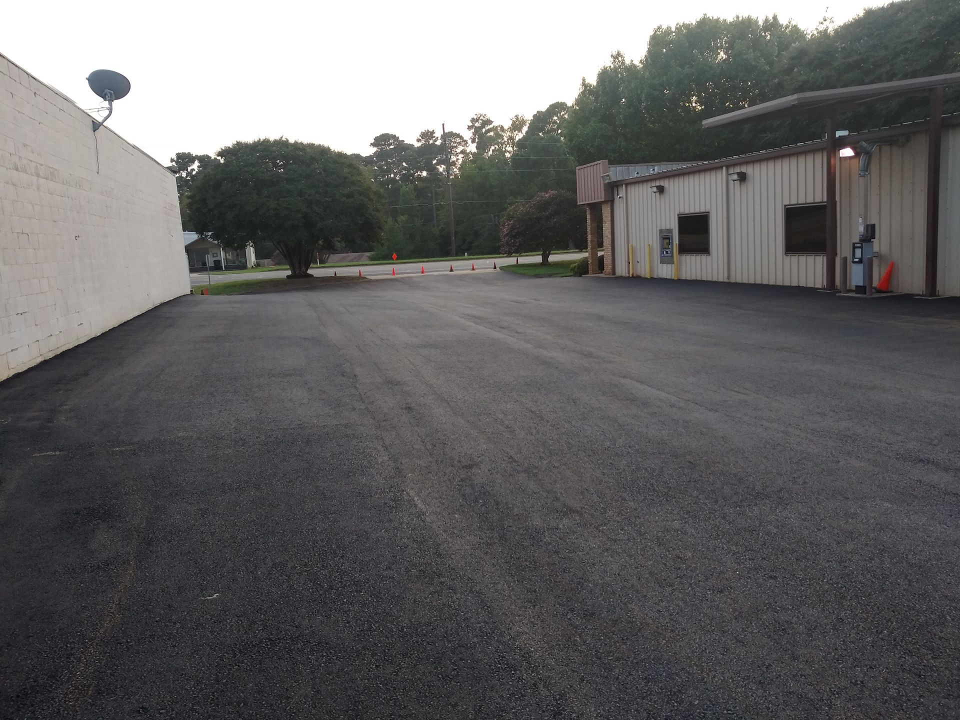 An empty parking lot with a building in the background