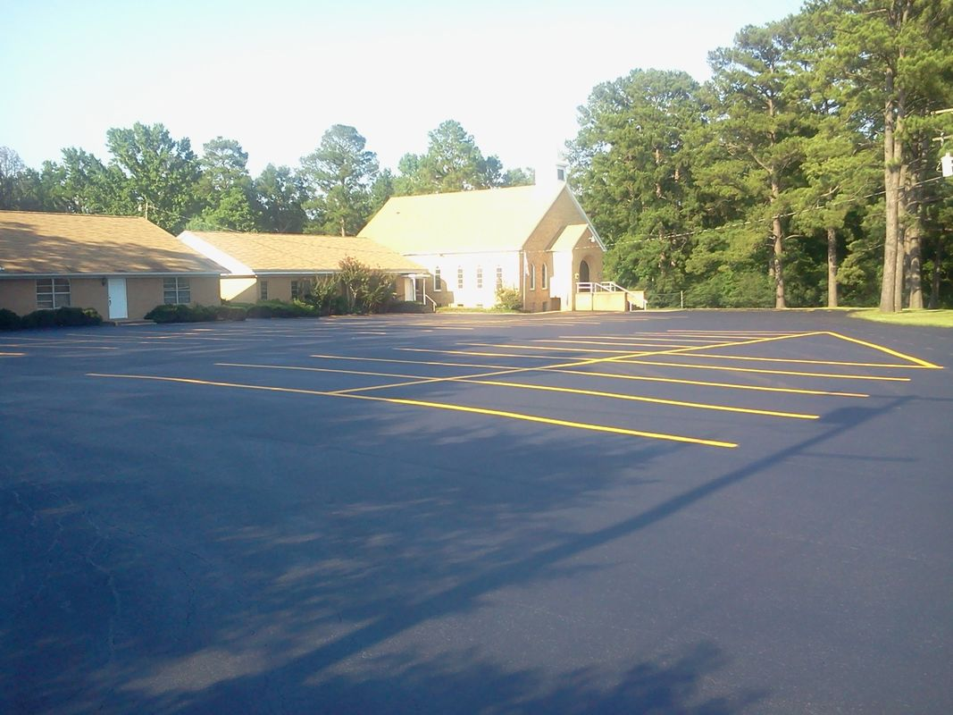 A parking lot with a church in the background