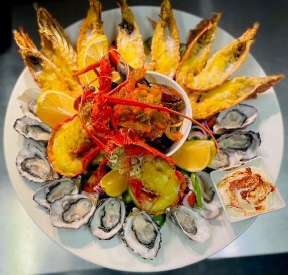 freshly prepared dish served with a glass of  wine
