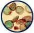 Microscopic view of round, colorful cells, possibly biological, with varying shades of green, red, and brown.