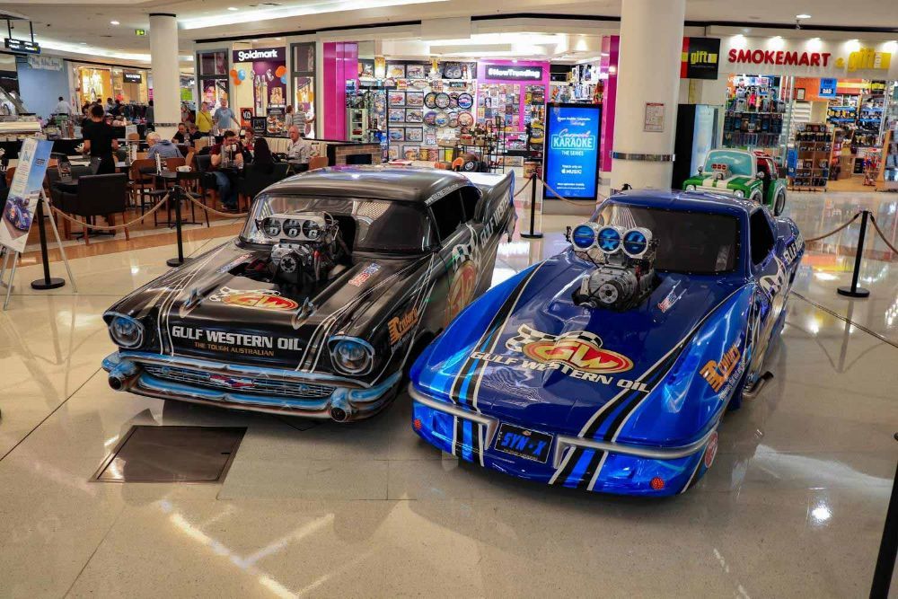 Two Drag Racing Cars Are Parked Next to Each Other in A Mall — Wades Distributors In Mackay, QLD
