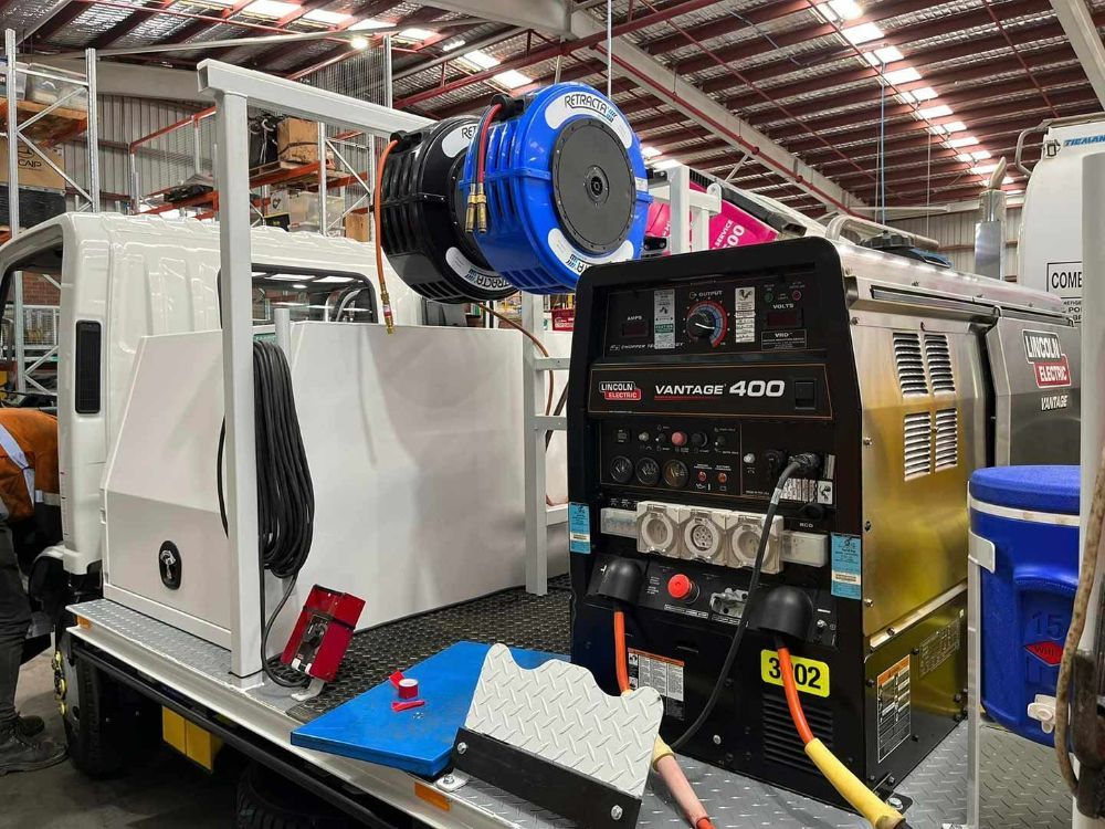 A Machine Is Sitting on The Back of A Truck in A Warehouse — Wades Distributors In Garbutt, QLD