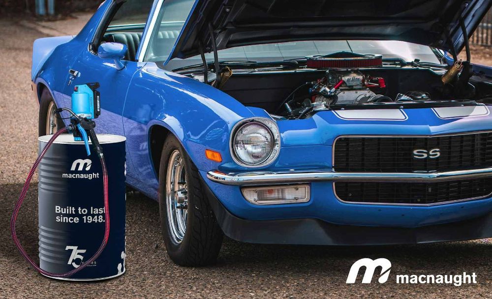 A Blue Car Is Parked Next to A Barrel of Macnaught Oil — Wades Distributors In Cairns, QLD