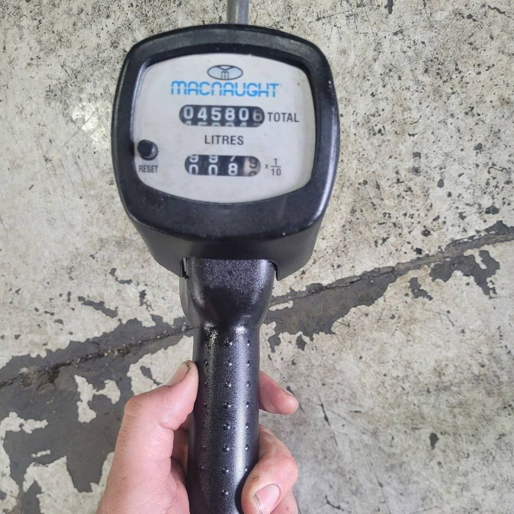 A Person Is Holding a Macnaught Meter in Their Hand — Wades Distributors In Whitsundays, QLD