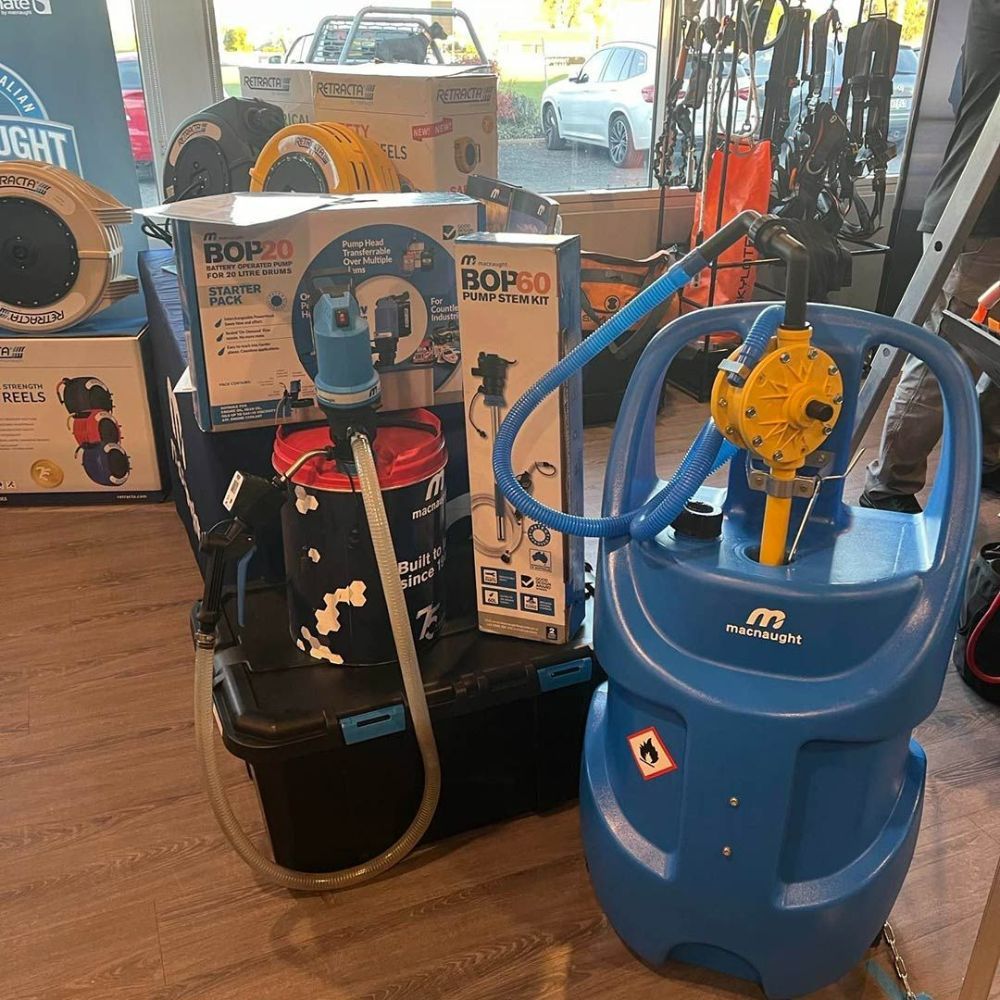 A Vacuum Cleaner Is Sitting on A Wooden Floor Next to A Bucket of Oil — Wades Distributors In Garbutt, QLD