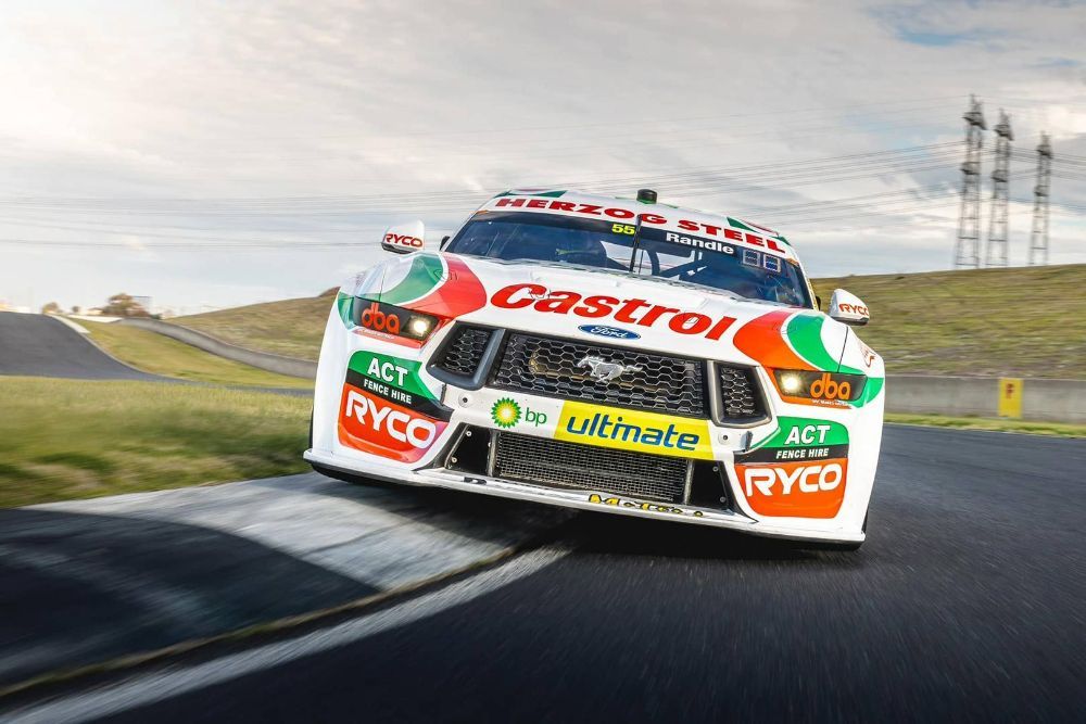 A Racing Car Is Driving Down a Race Track — Wades Distributors In Mackay, QLD