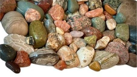 Assorted polished pebbles and colorful stones arranged in a pile