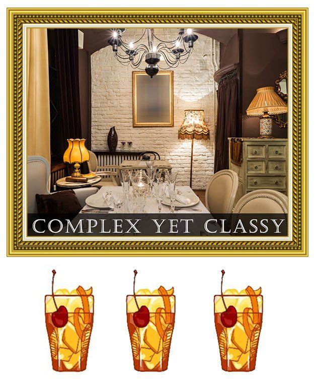 Elegant bedroom with gold frame and “COMPLEX YET CLASSY” text above three cocktails with fruit garnish