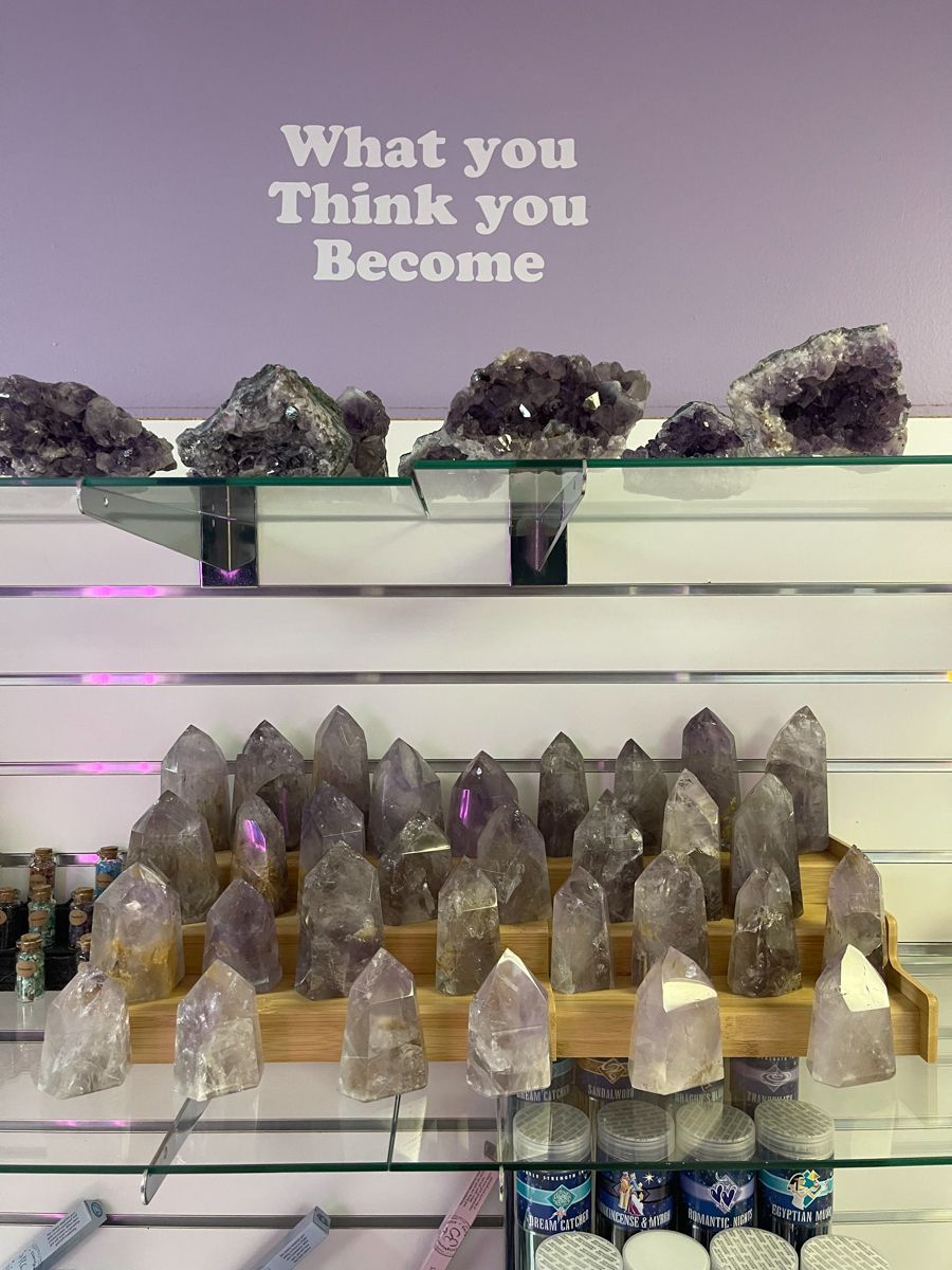 Crystals on shelves in a shop, purple hues. Text above: 
