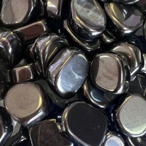 Pile of polished, shiny black hematite stones.