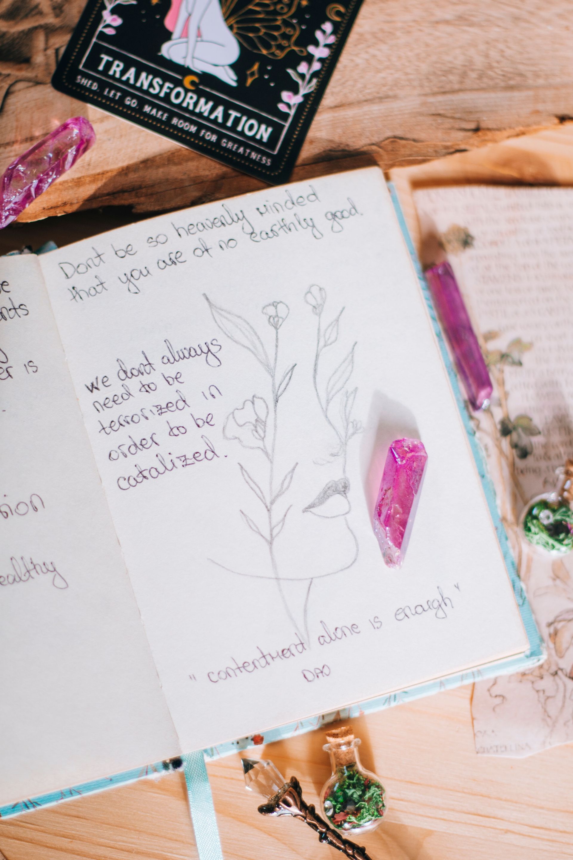 Woman reflecting on midyear goals with crystals and a journal
