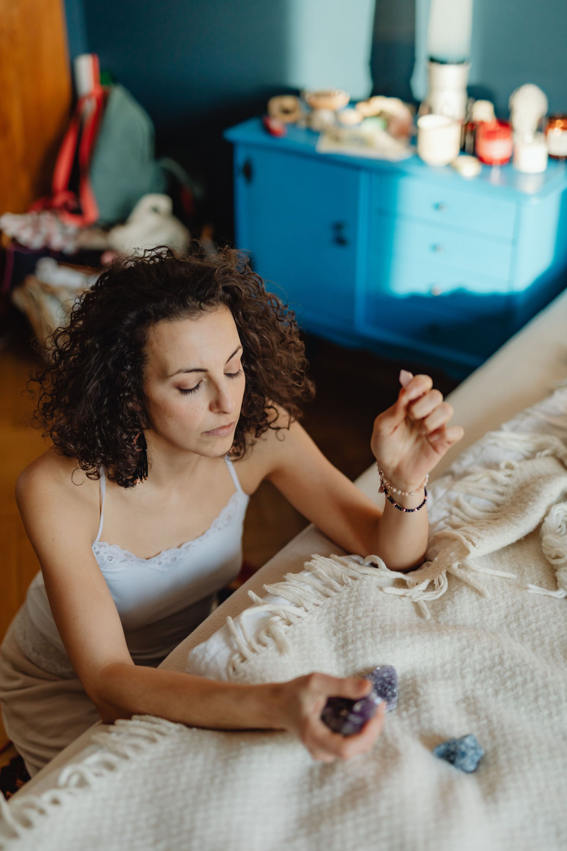 Woman preparing a summer solstice ritual with crystals and a journal