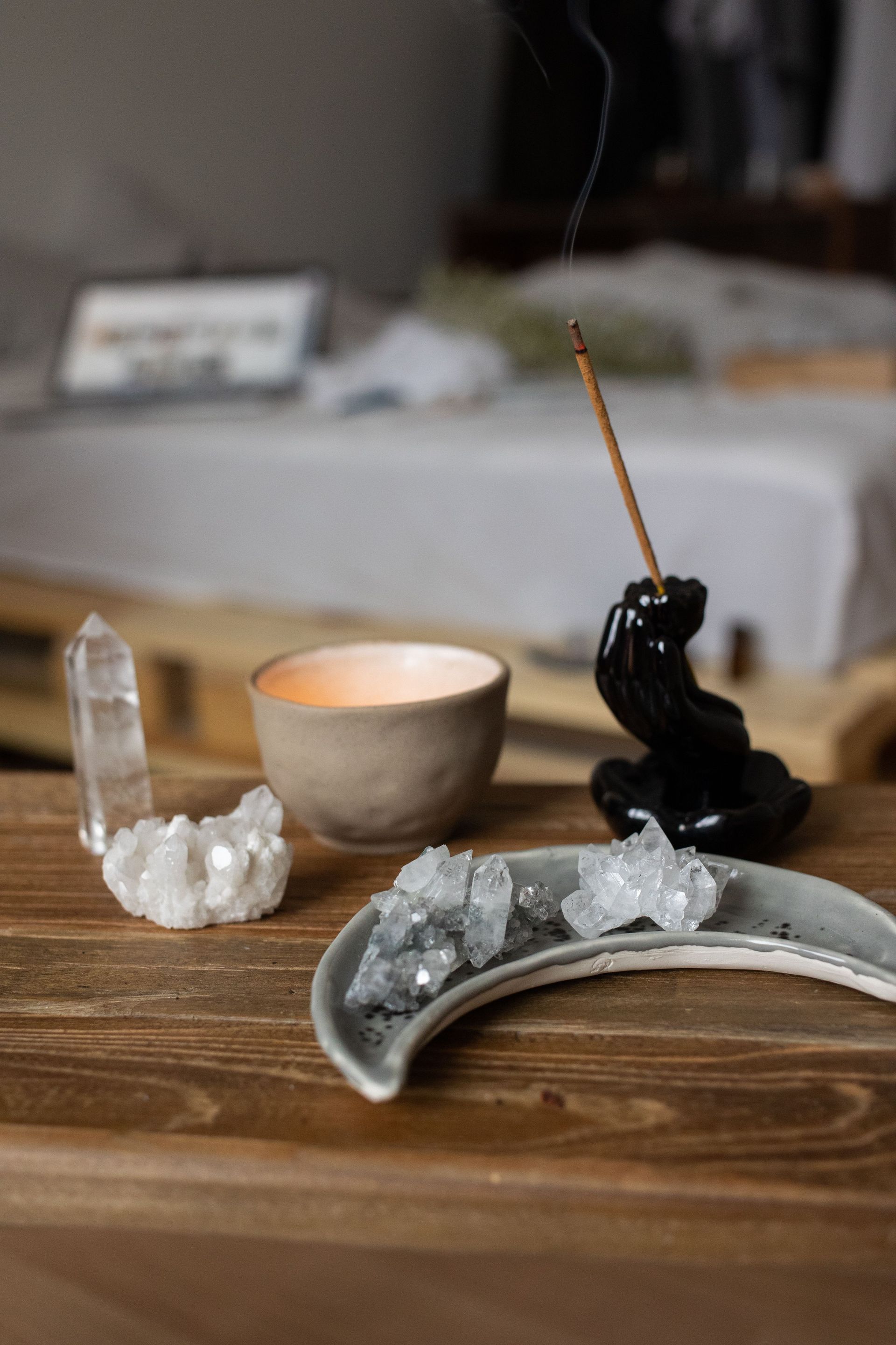 Woman preparing a grounded spiritual cleansing ritual with crystals and incense