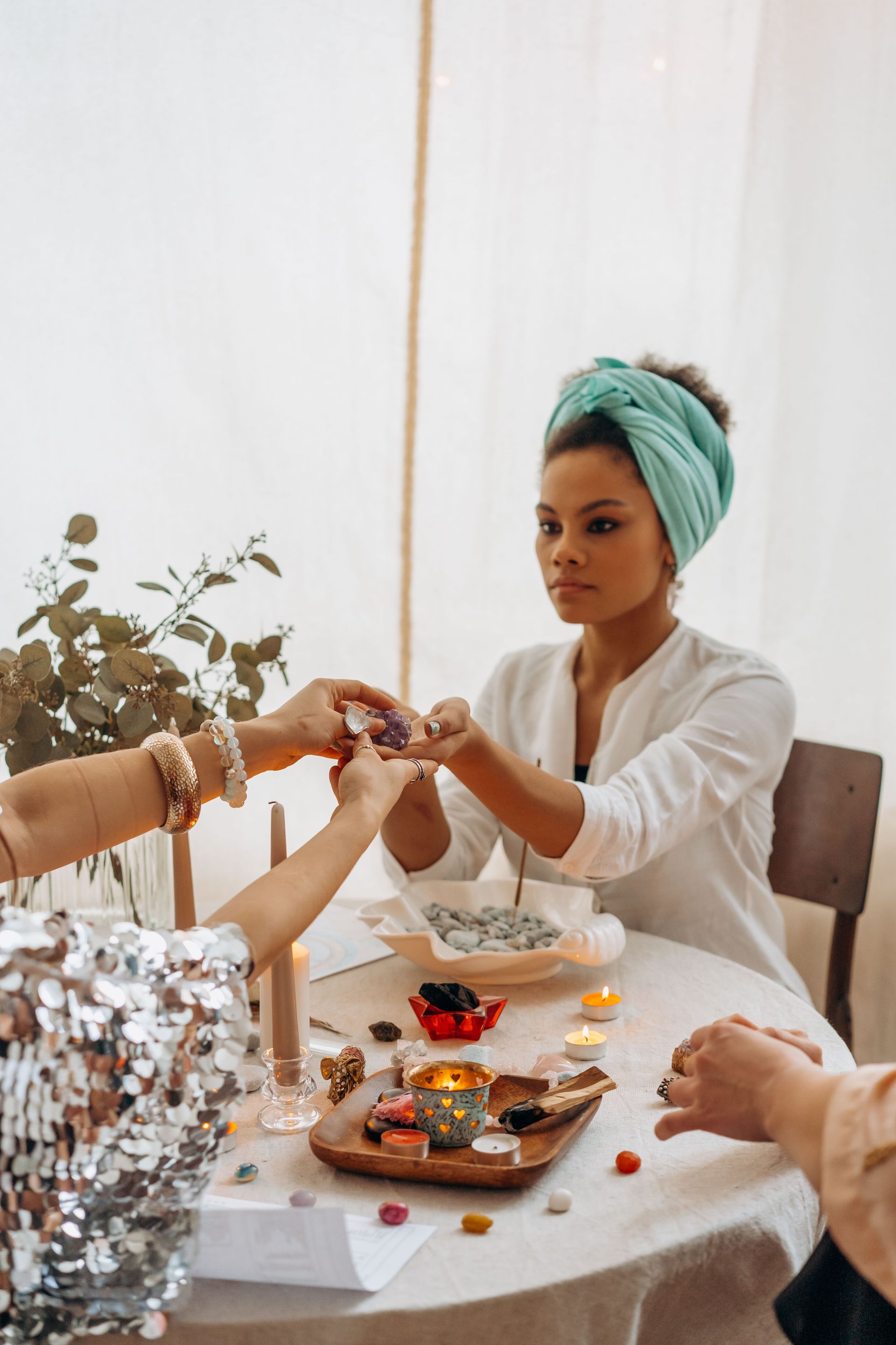 Woman creating a simple sacred space at home with crystals and incense