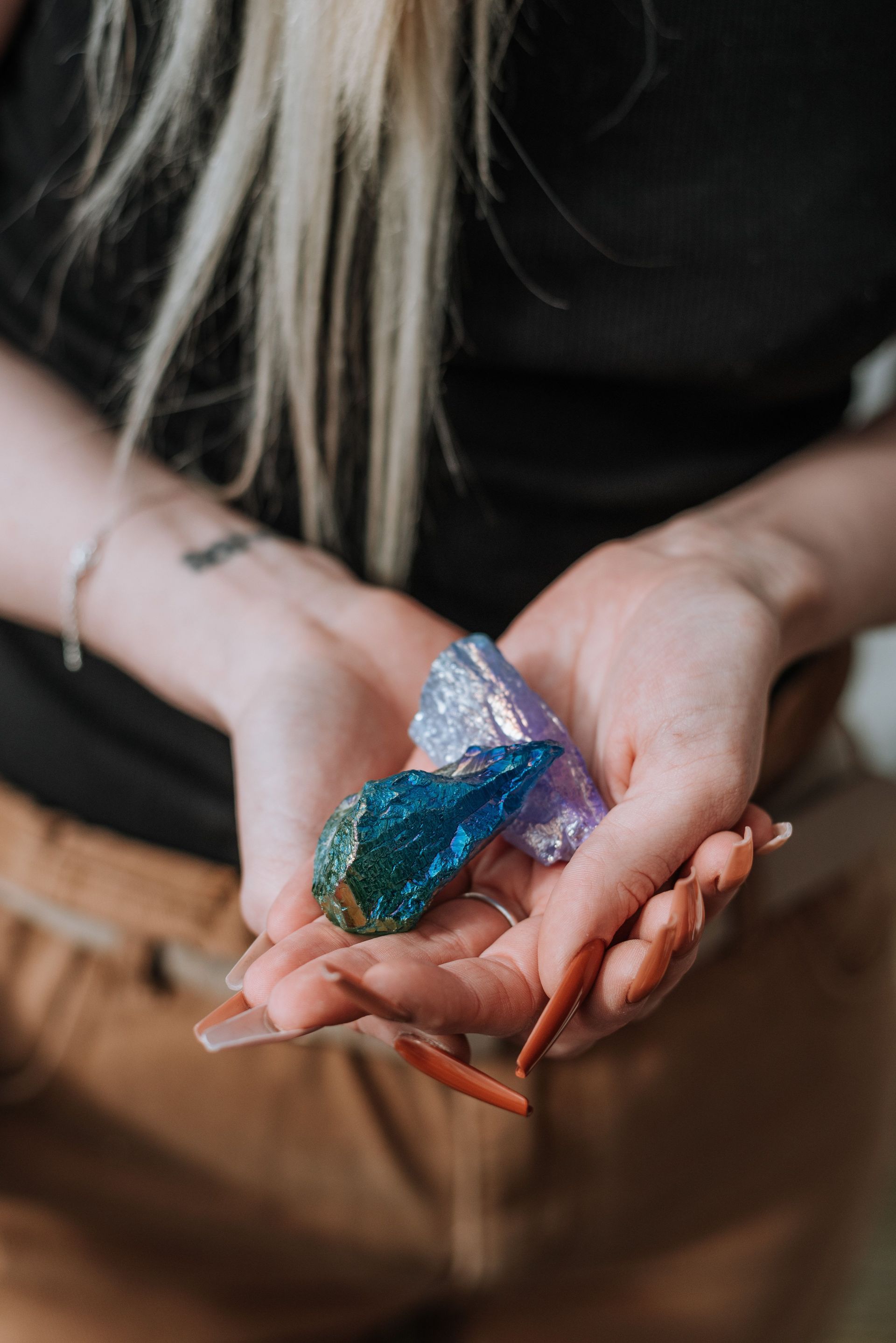 Woman choosing crystals for a beginner collection in a boutique