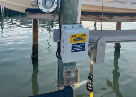 Dock-mounted electrical control box on a wooden pier above the water
