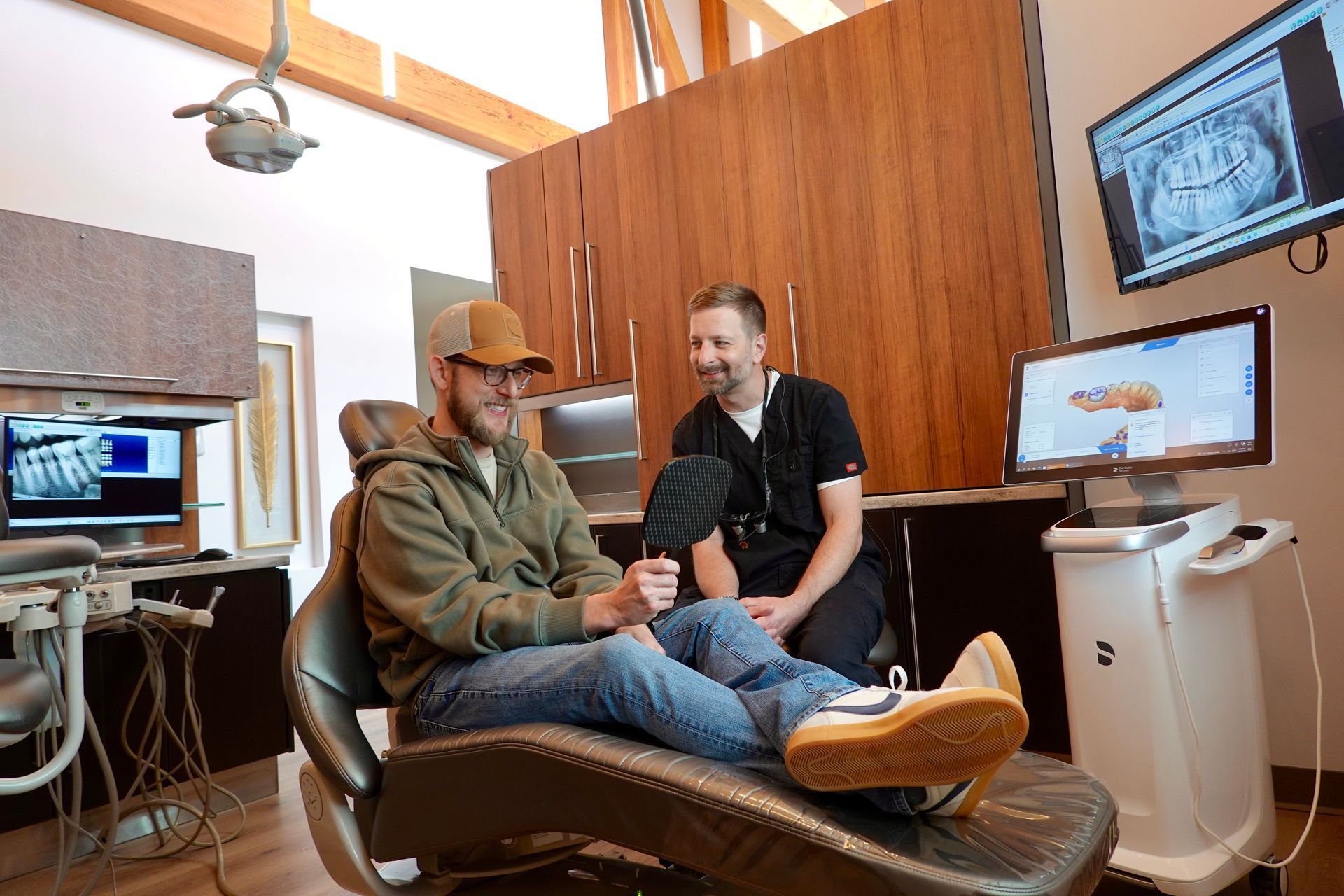 Dr. Eric and patient viewing a new crown