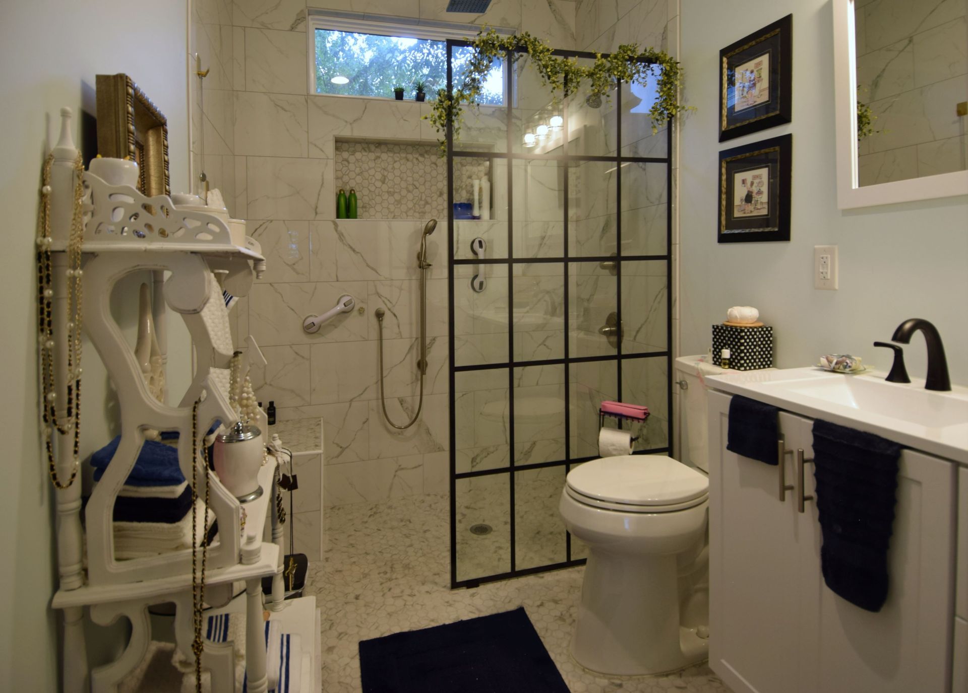 A bathroom with a toilet , sink and walk in shower.