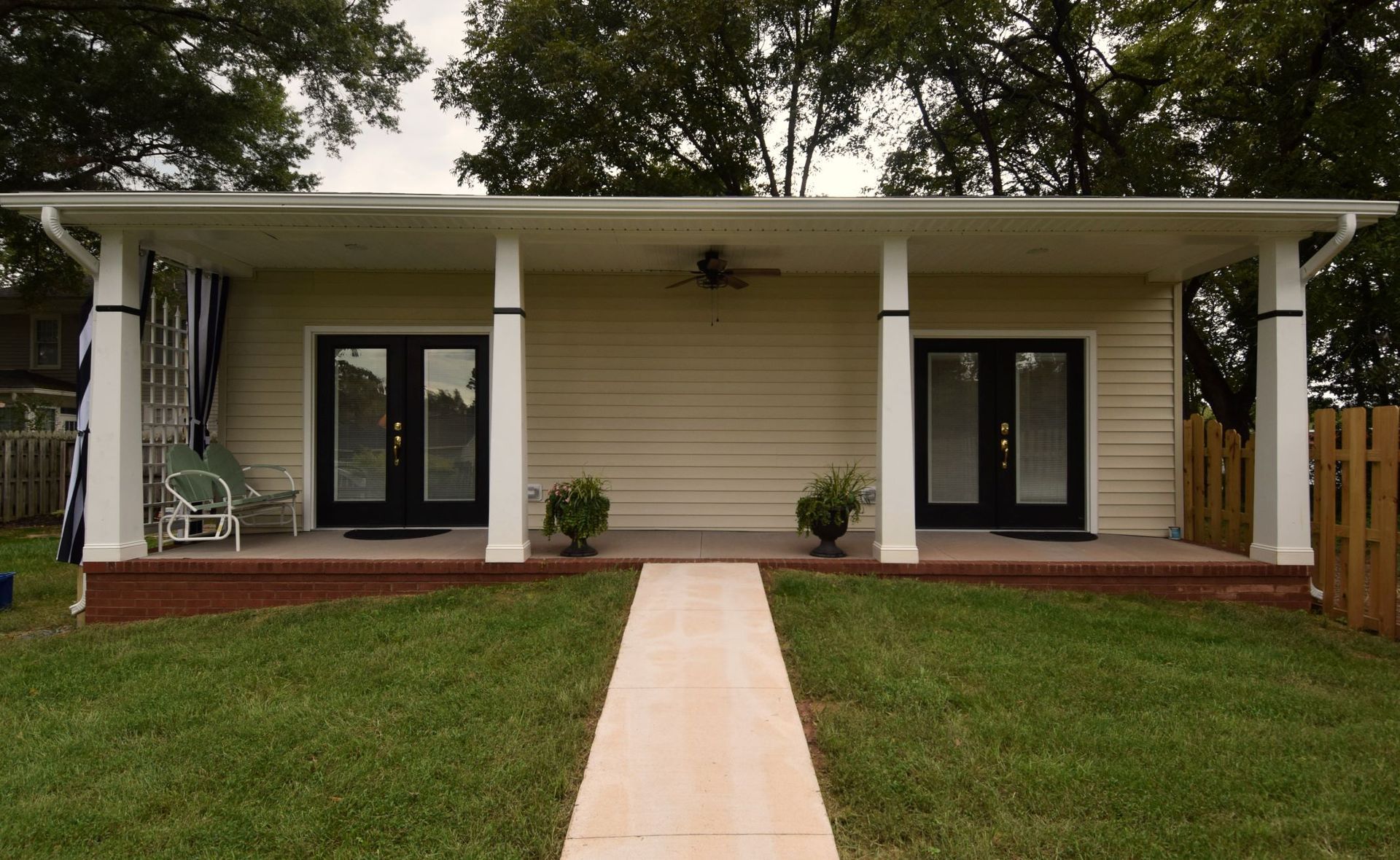 A small house with a porch and a walkway leading to it