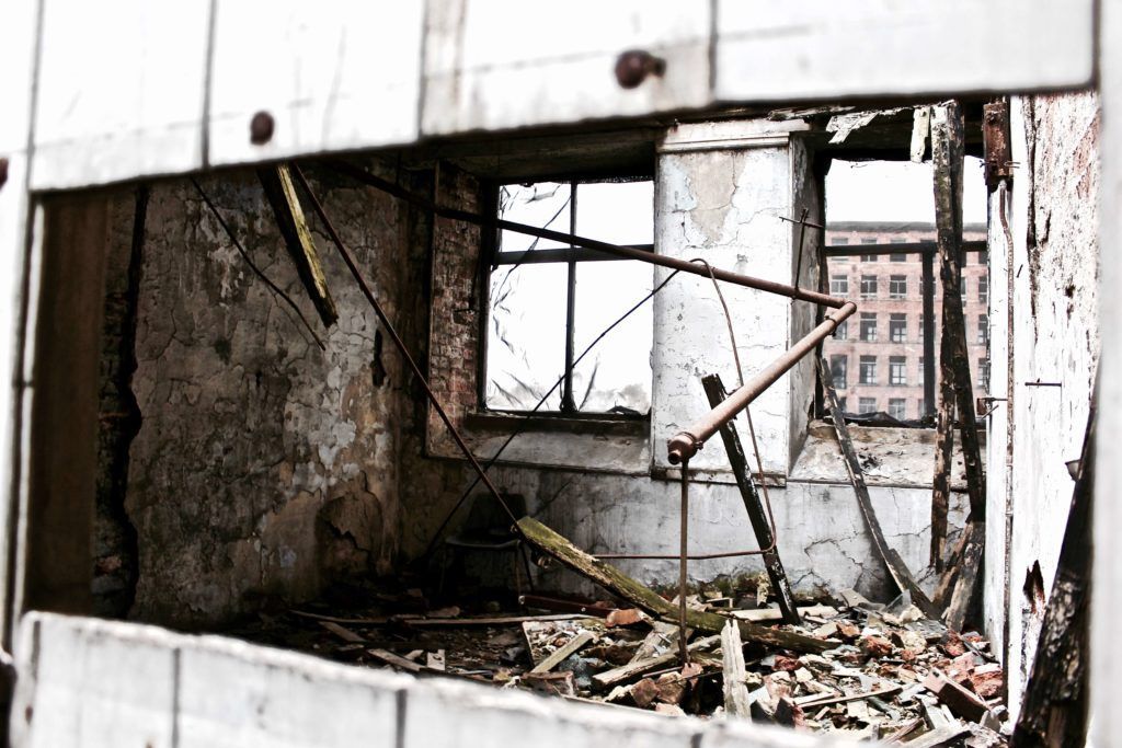 A room in an abandoned building with a broken window.