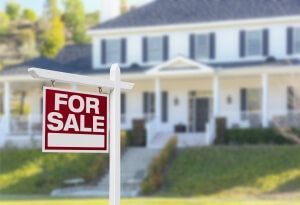 A for sale sign in front of a house
