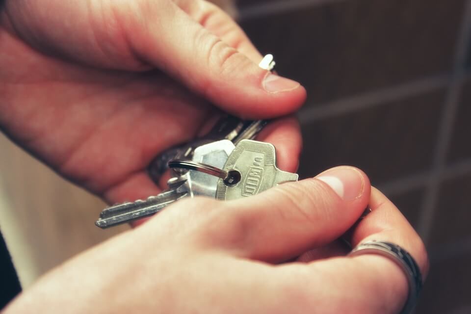 A person is holding a bunch of keys in their hands.