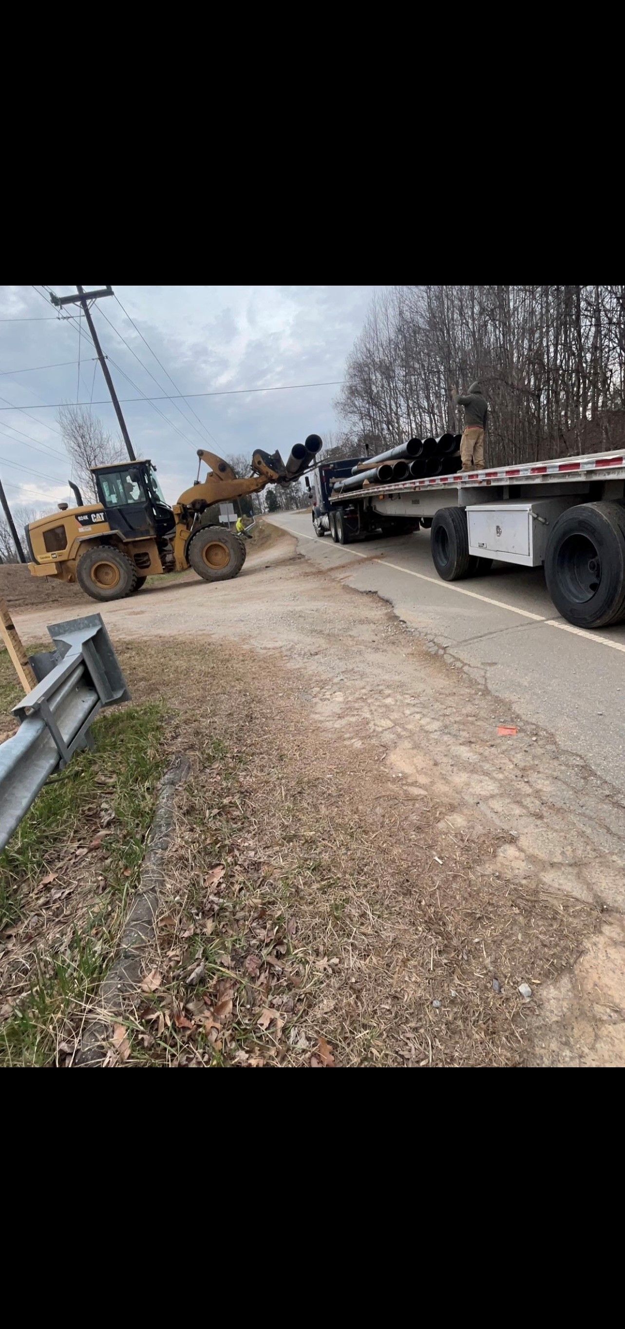 Bulldozer is Driving Down a Dirt Road Next to a Semi Truck | Weaverville, NC | Appalachian Trucking LLC