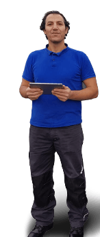 A person wearing a blue polo shirt and grey cargo pants stands holding a tablet, looking toward the camera.