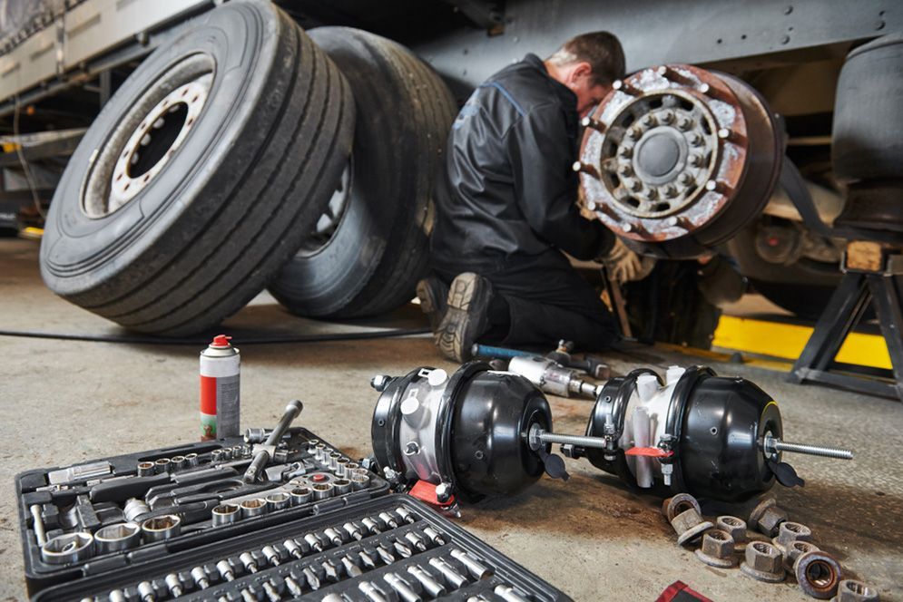 A Man Is Working On A Truck In A Garage — SteelBar Restoration In Yarraman, QLD