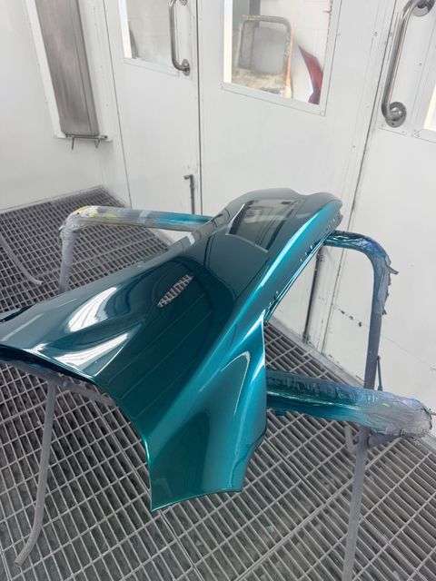 Teal Motorcycle Fairing Being Spray-painted — SteelBar Restoration In Yarraman, QLD