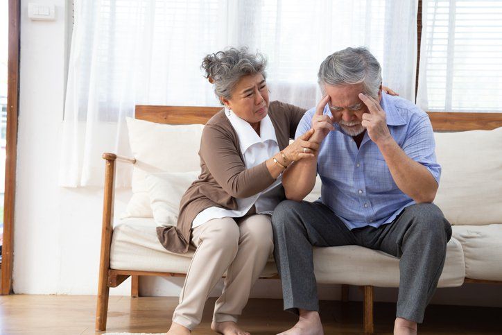 Asian senior retired couple holding hands and take care together