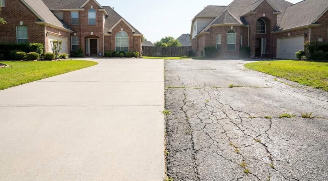 A driveway split between smooth new concrete and cracked old pavement in a suburban neighborhood.