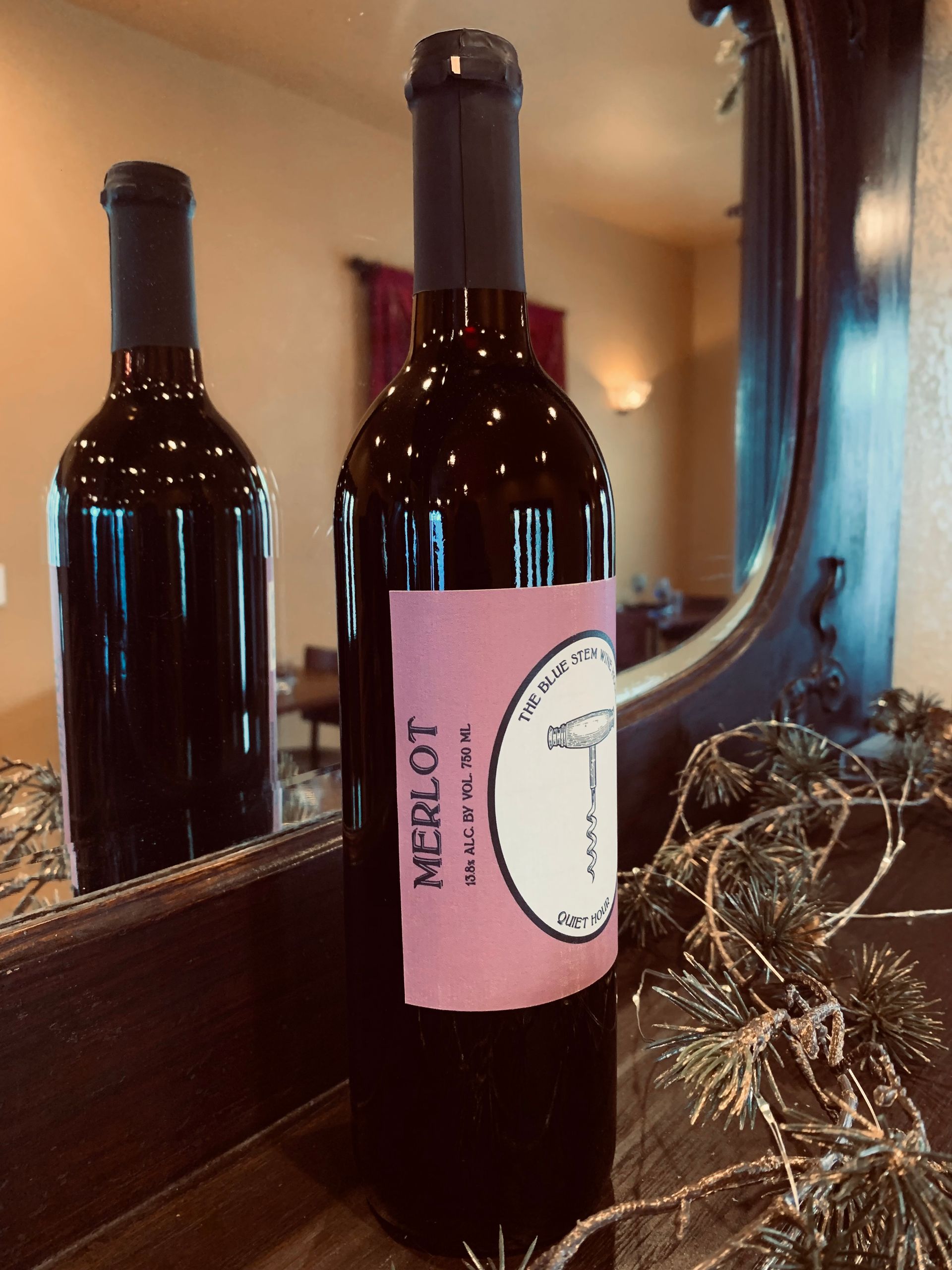 A bottle of Merlot wine with a corkscrew on the label