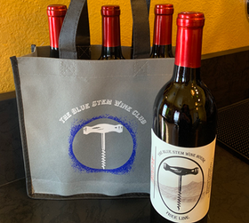 the Blue Stem wine club tote with three bottles of wine included in it. bottle of wine next to tote.