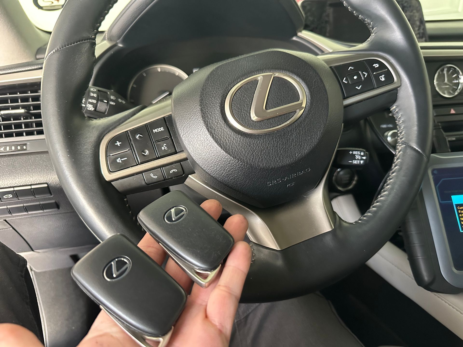 A hand holding a remote control.