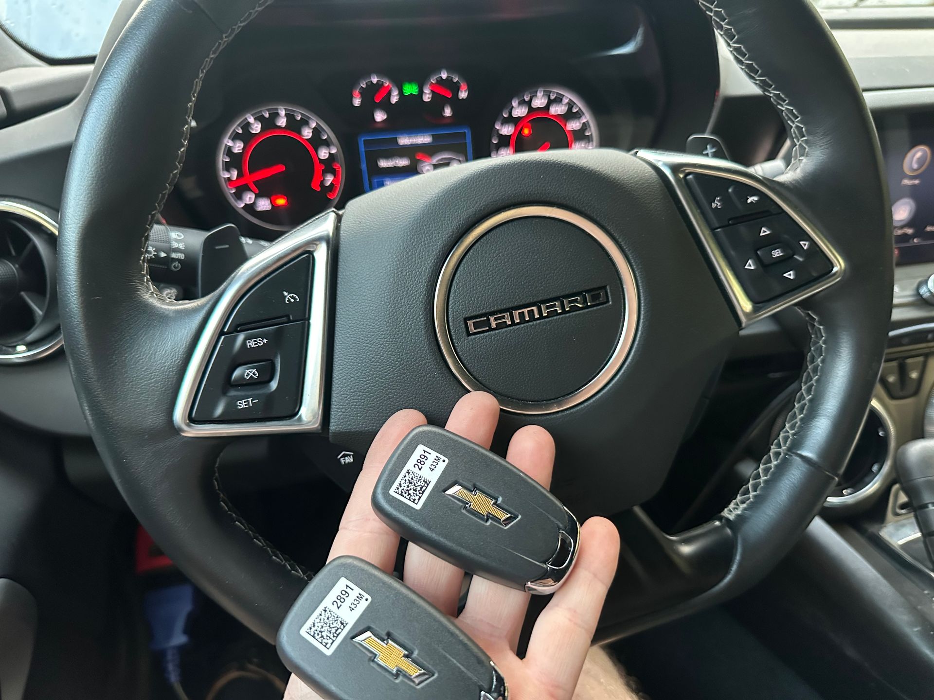 a hand holding a remote key fob for a vehicle