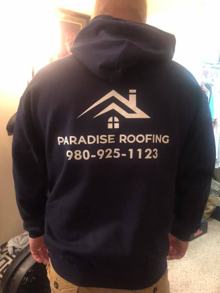 A man is wearing a hoodie that says paradise roofing