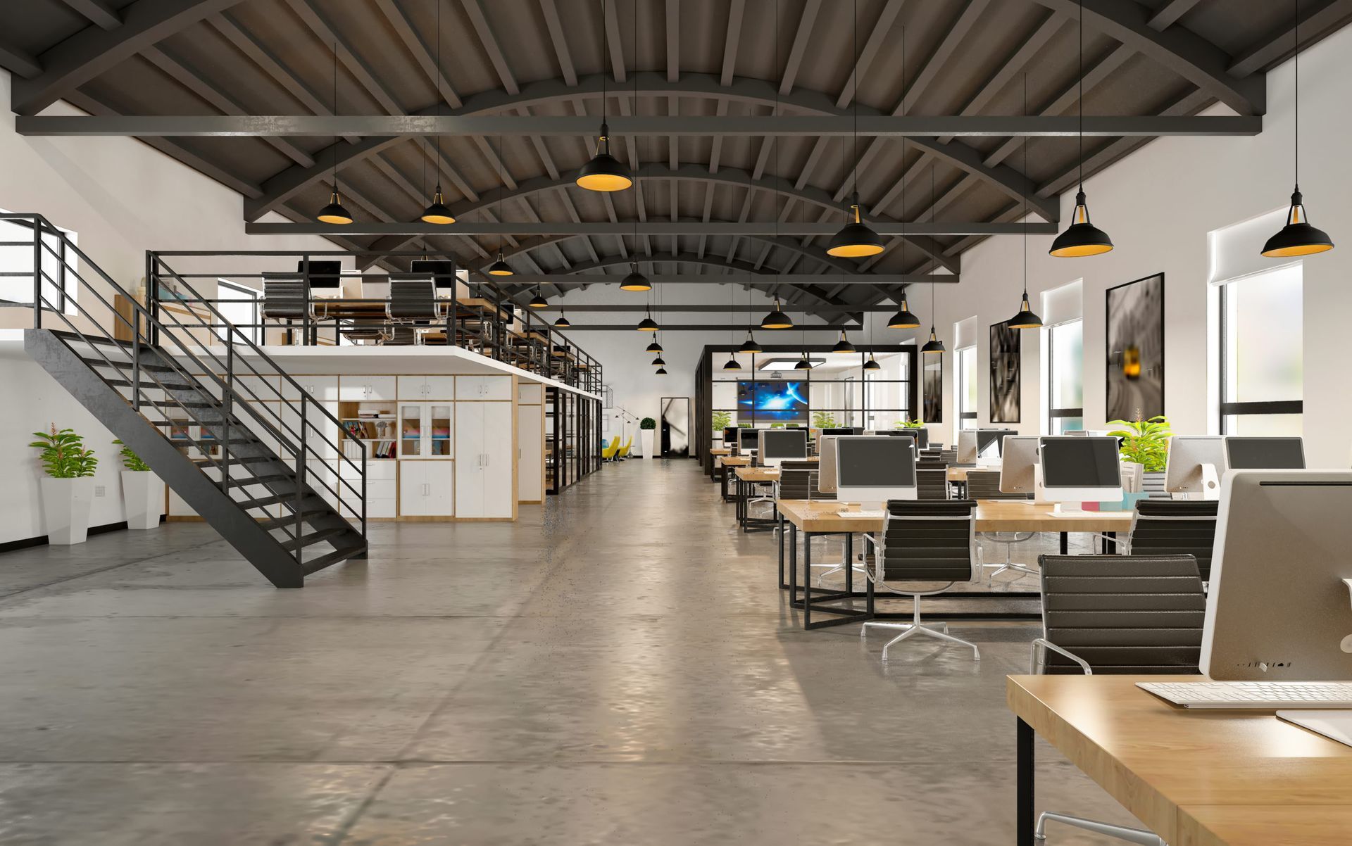 Spacious modern loft office with exposed beams, stairs, desks, and lounge seating under pendant lights