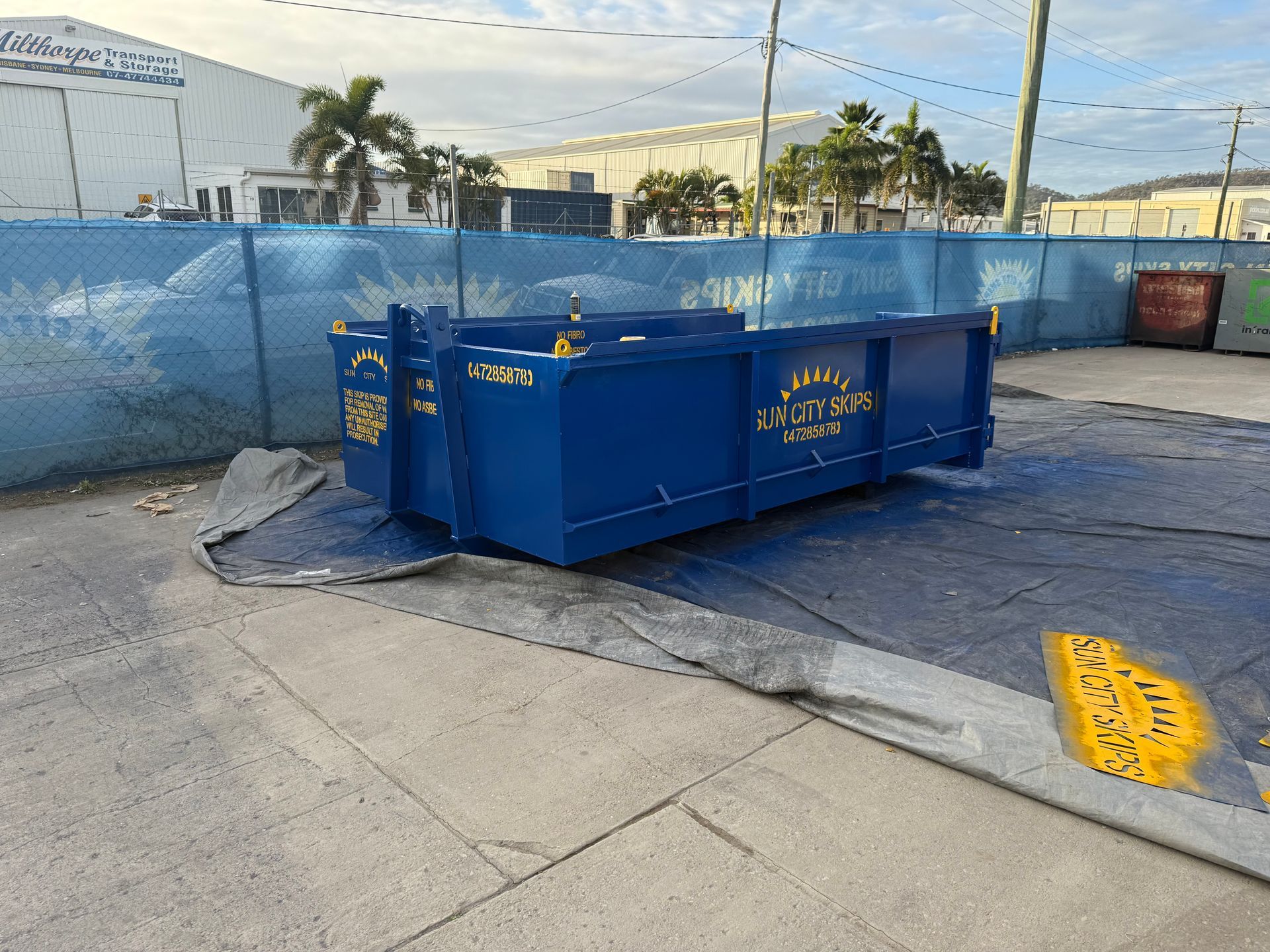 A Blue Dumpster Truck Is Filled With Wood — Sun City Skips In Bohle, QLD