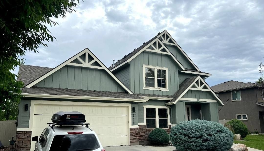 A large house with two garage doors and a driveway