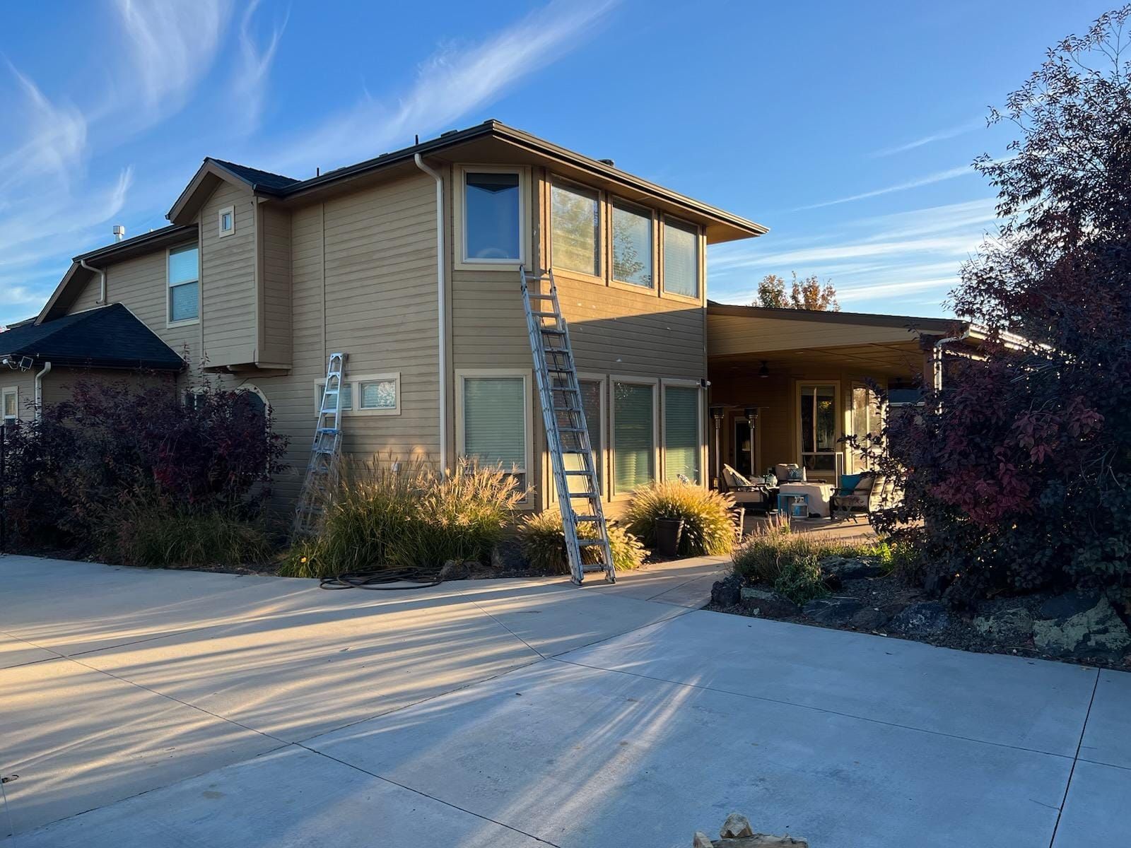 A large house with two garage doors and a driveway