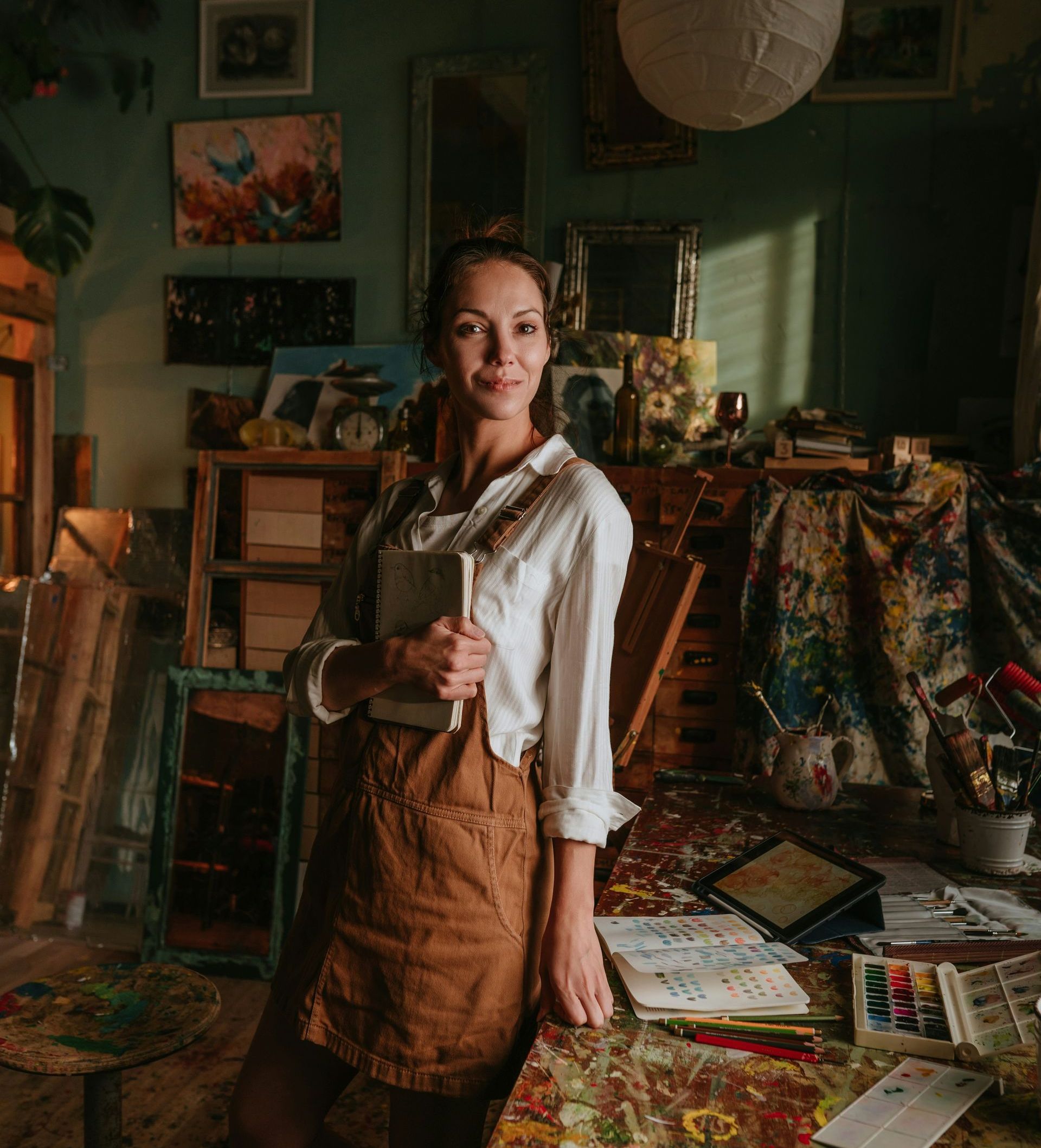 A woman is standing in a room holding a book.