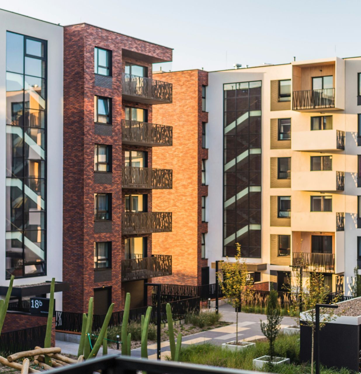 A row of apartment buildings with a brick building in the middle