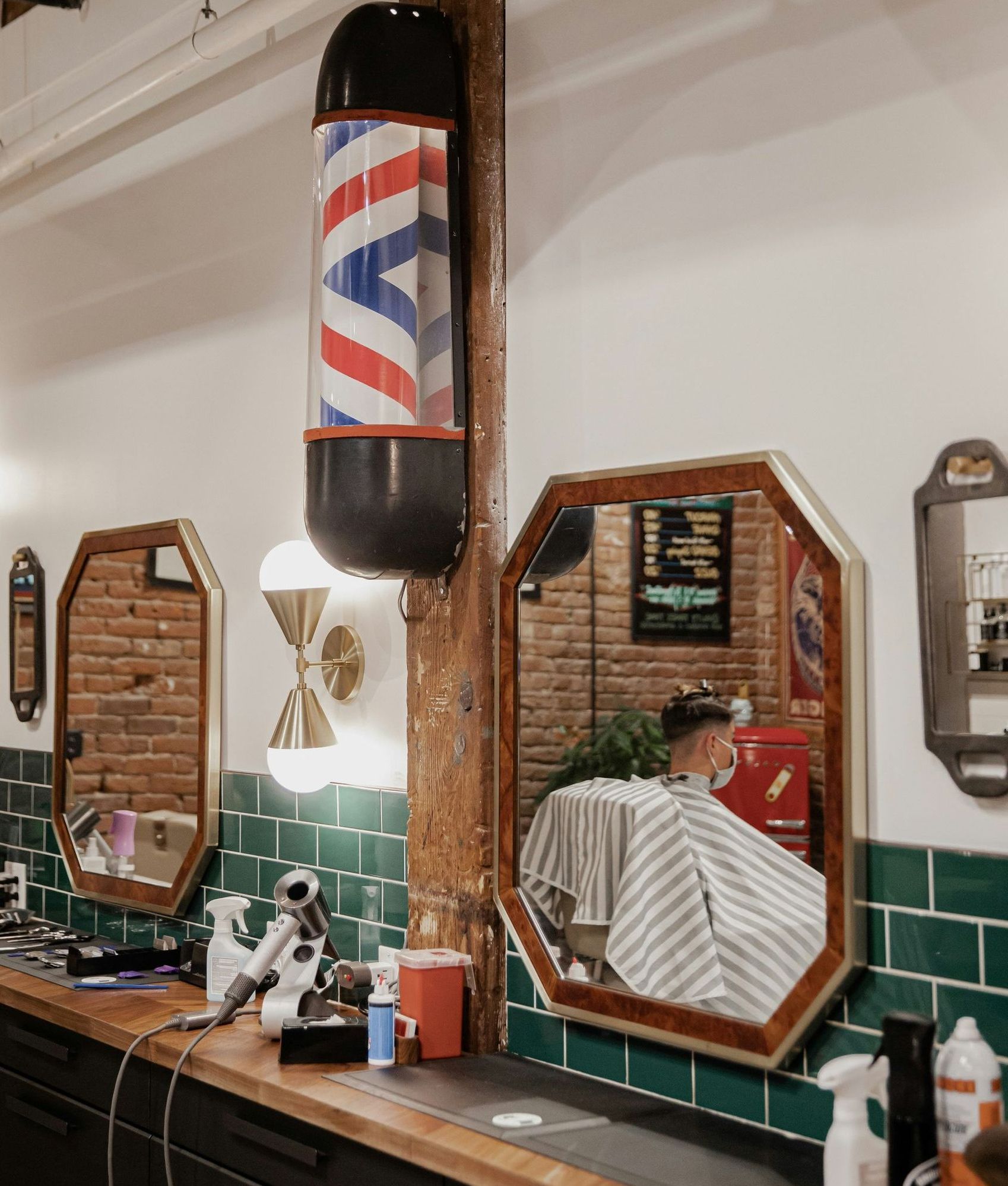 A man is getting his hair cut in a barber shop