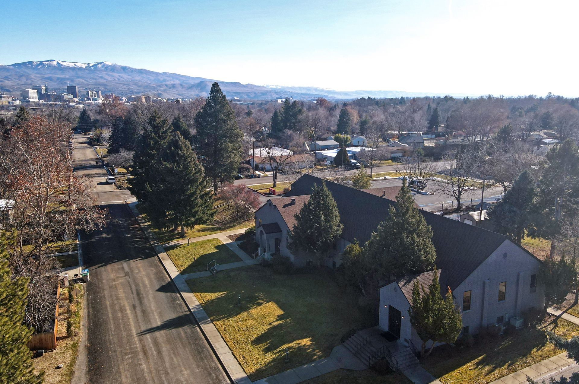 An aerial view of a house with mountains in the background