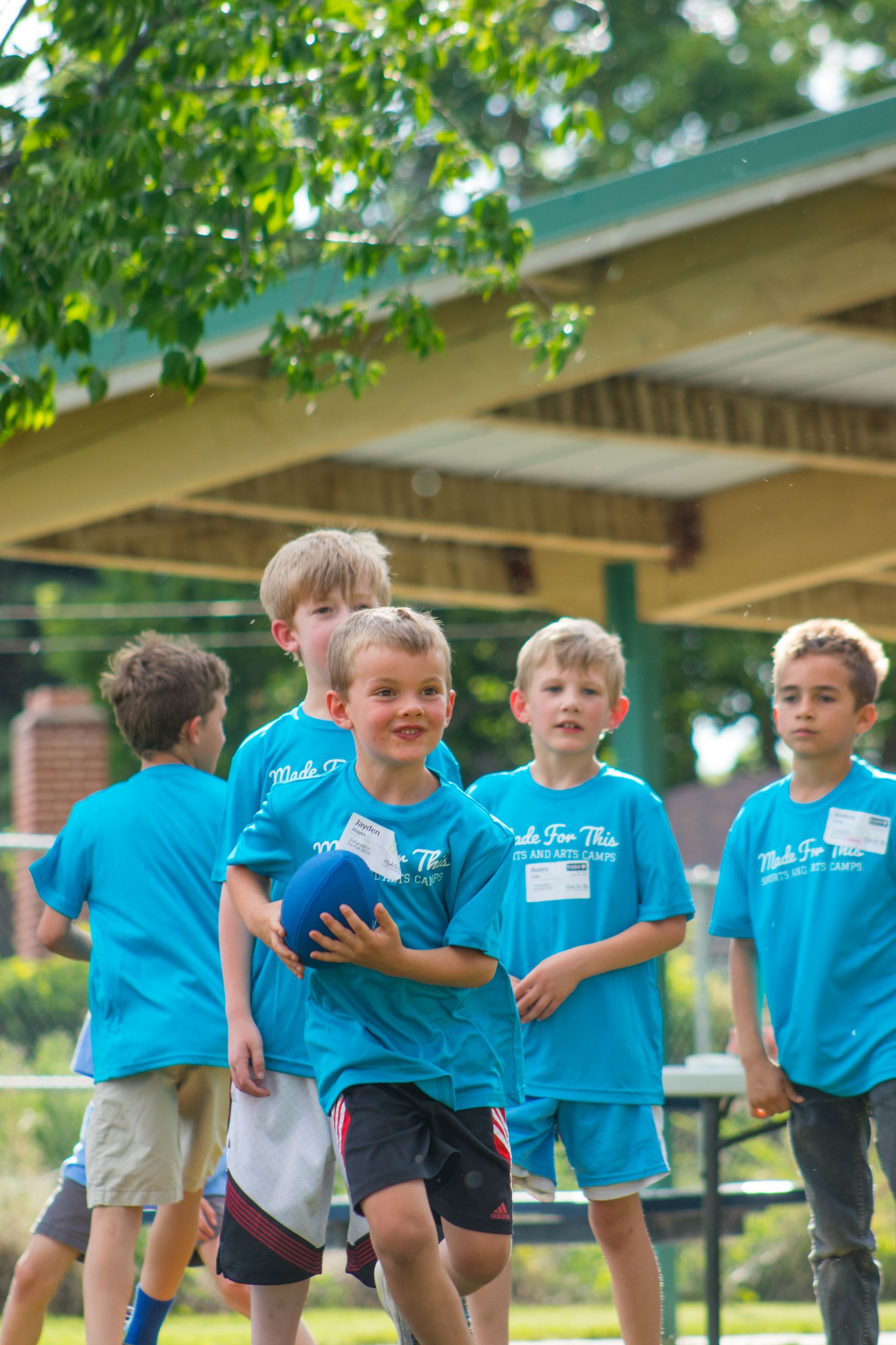 A group of young boys are playing soccer in a park.