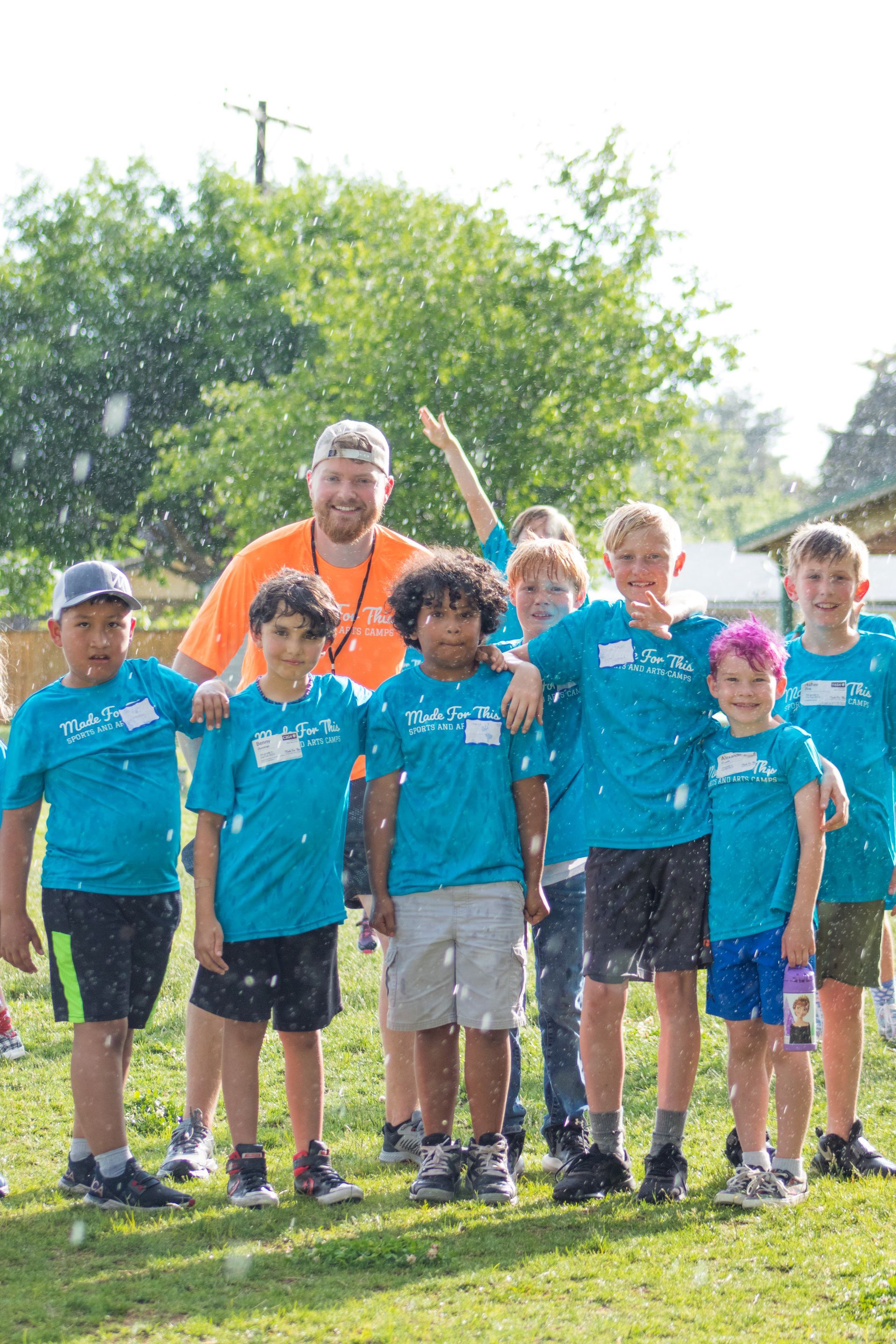 A group of young boys are posing for a picture in a field.