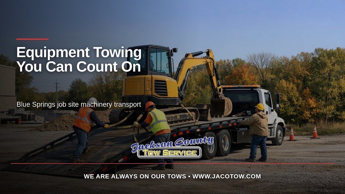 Illustrative flatbed truck and equipment at a job site, with Jackson County Tow Service branding and headline.