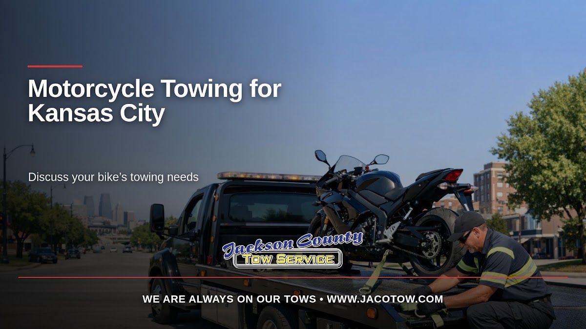 A tow truck operator beside a motorcycle on a flatbed illustrates motorcycle towing in the Kansas City metro area.