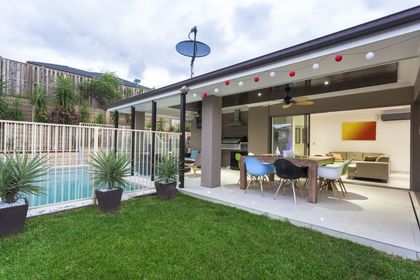 Modern backyard with pool and outdoor living area.